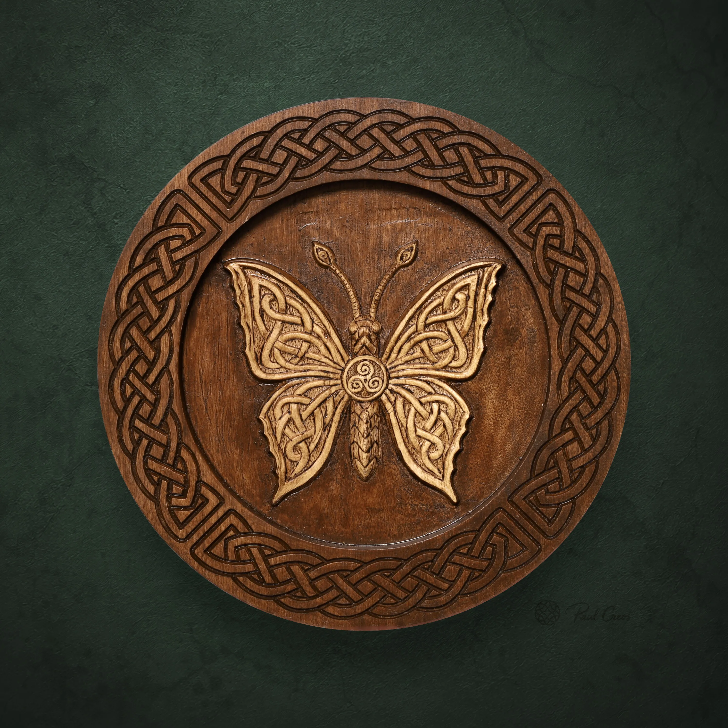 Moth I wooden roundel with an ornate carved moth, central triskele, and Celtic knotwork border