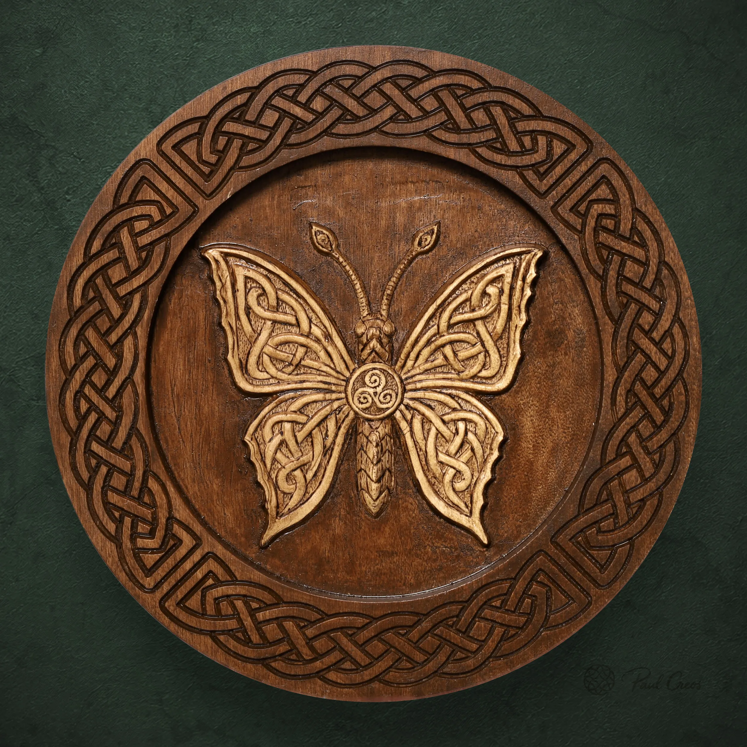 Moth I thumbnail showing a carved moth with a central triskele and Celtic knotwork border