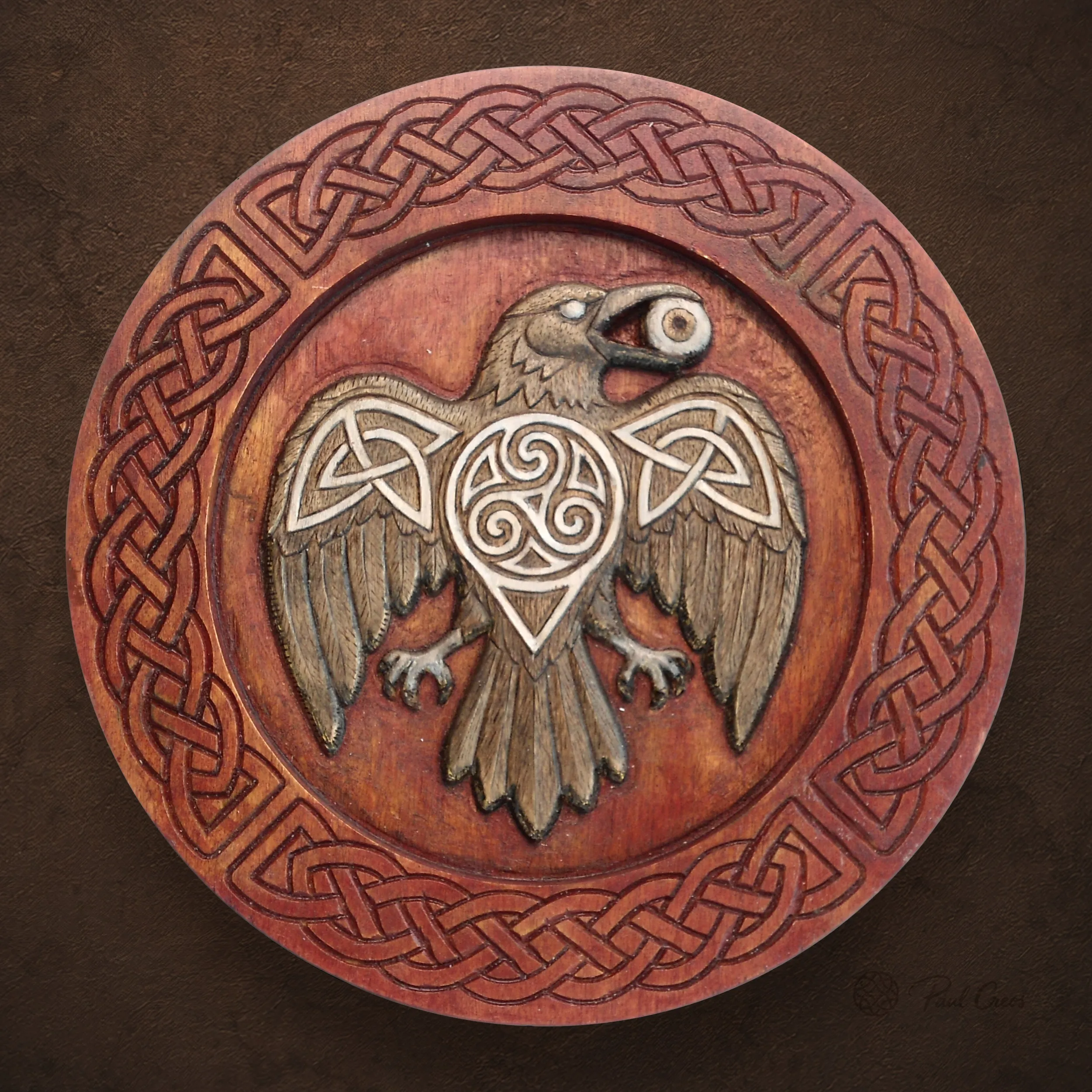 Raven Fire thumbnail showing a carved raven with a central triskele and Celtic knotwork border
