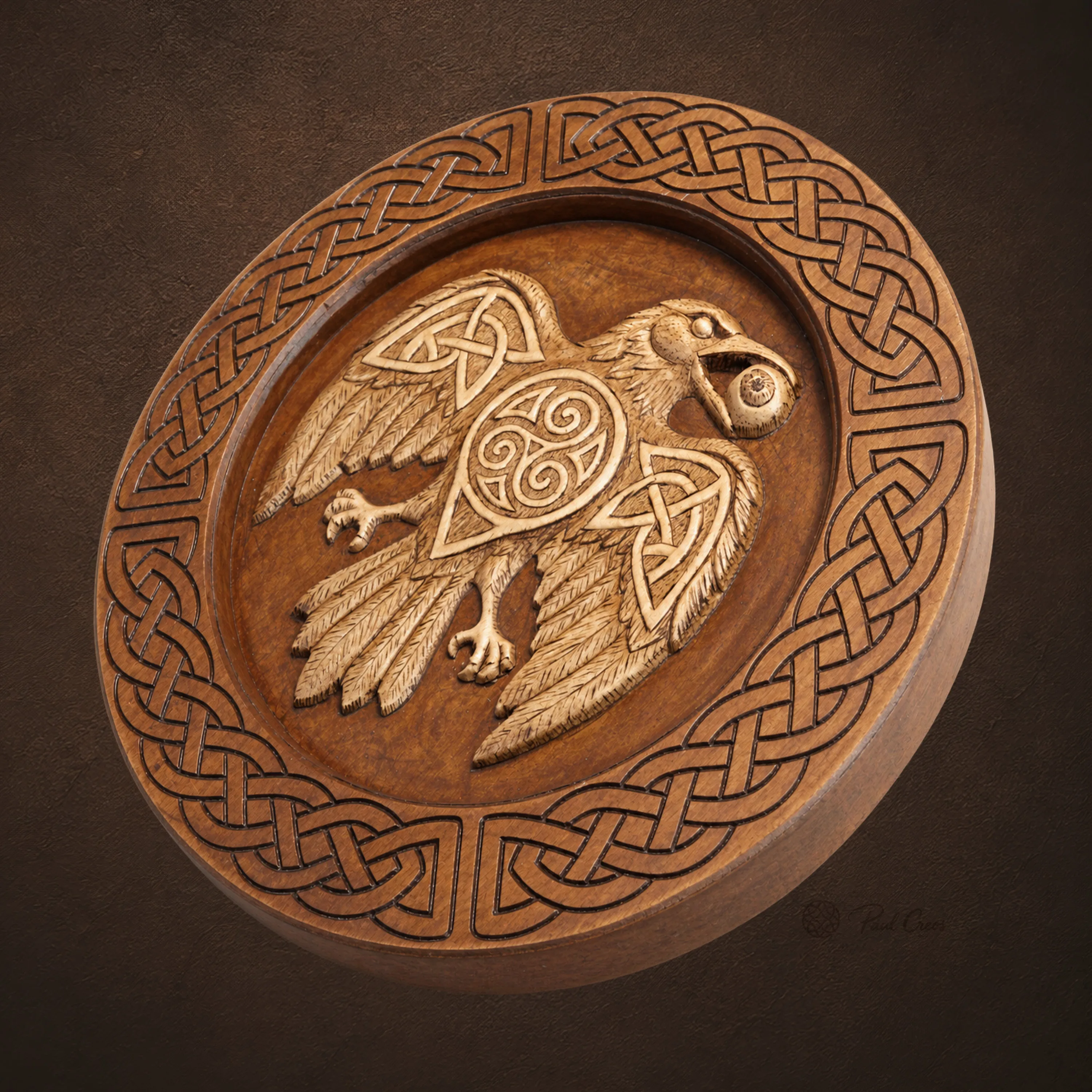 Angled view of Raven Warden II showing the carved raven, triskele, and Celtic knotwork border