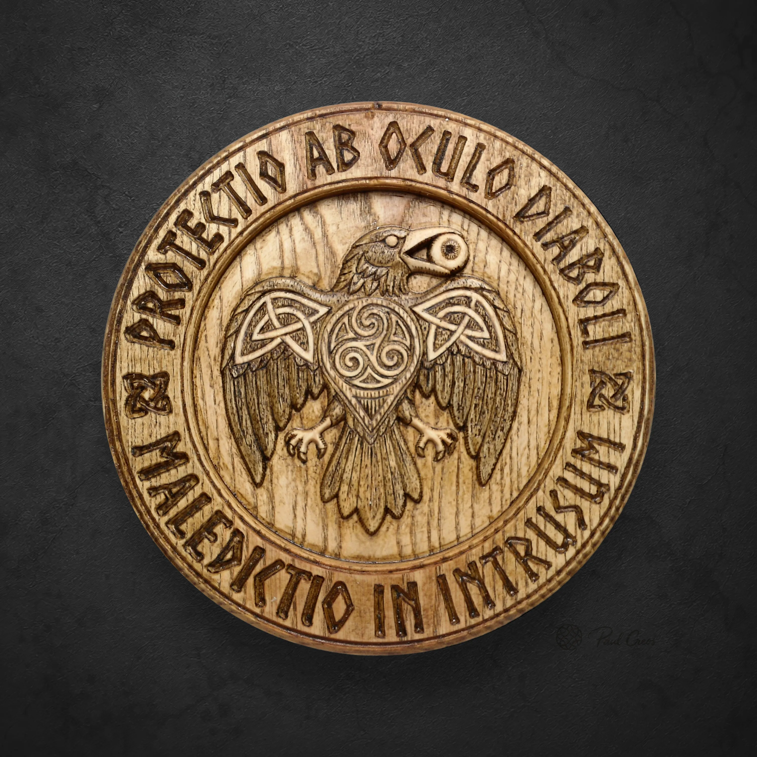 Raven Warden I wooden roundel with a carved raven, triskele, and circular Latin inscription