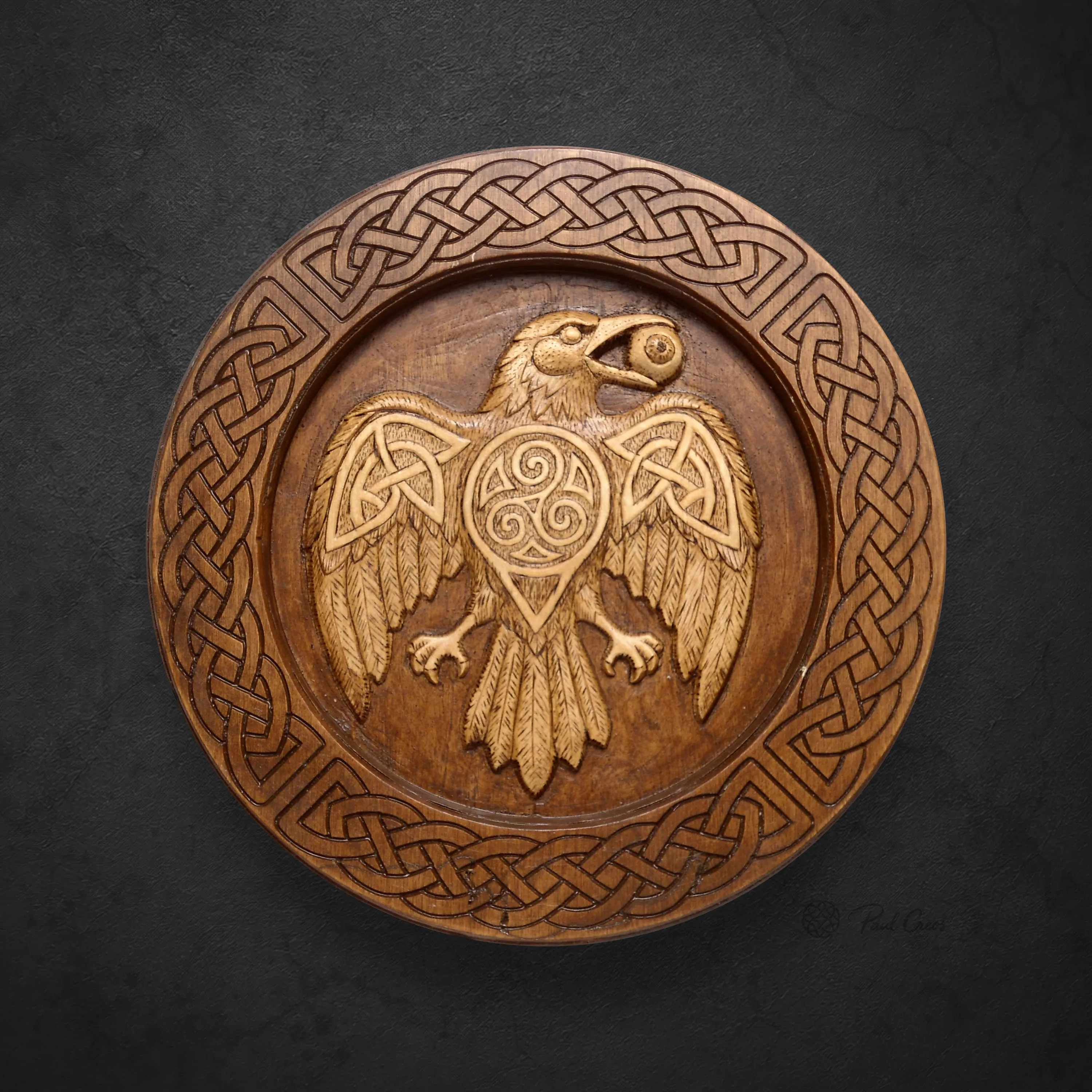Raven Warden II wooden roundel with a carved raven, triskele, and Celtic knotwork border